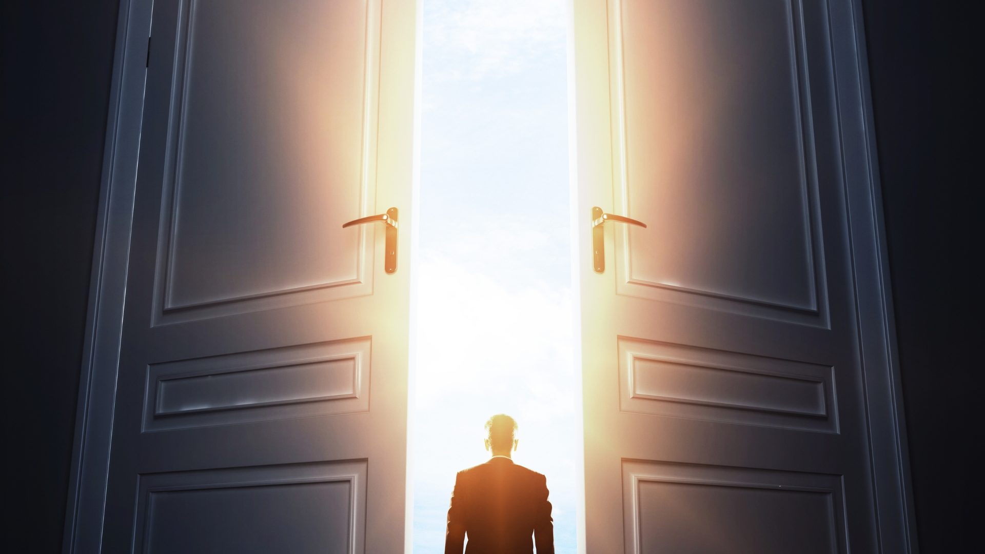 Tall doors opening onto bright light